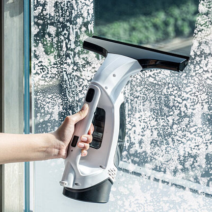 Cordless window cleaner removing water from glass